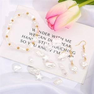 Baroque pearl jewelry set with elastic bracelet and hook earrings on white silk