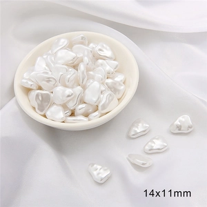 Macro detail of irregular 14x11mm baroque ABS pearls on silk for DIY jewelry making