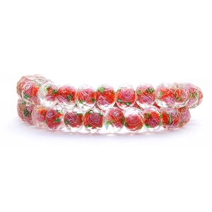 Close-up of faceted crystal glass beads with red rose pattern for DIY jewelry making