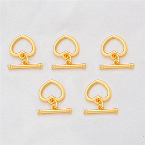 Detailed view of five 18K gold-plated heart-shaped toggle clasps for jewelry making