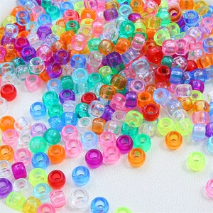 Macro shot of colorful transparent acrylic pony beads with large holes for DIY hair jewelry