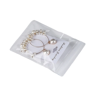 Golden pearl hoop earrings packaged in a transparent PVC self-sealing jewelry bag