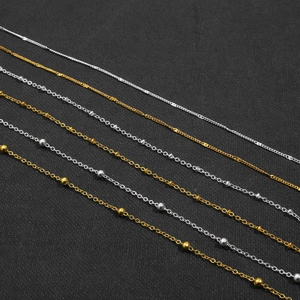 Detail of gold and silver iron O-chains with spacer beads for DIY eyewear and jewelry