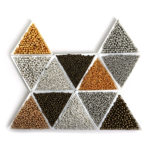 Macro view of assorted metal spacer beads in triangular trays for DIY jewelry making