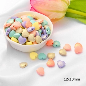 Macro detail of 12x10mm pastel macaron heart-shaped acrylic beads for DIY jewelry making