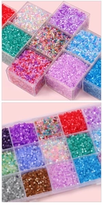 Macro detail of 2.5mm colorful antique cat eye beads in a transparent plastic storage box