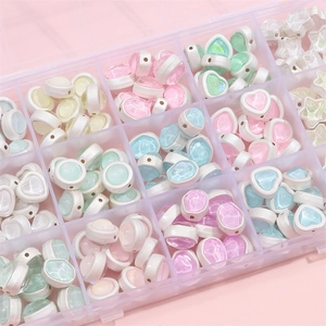 Macro detail of star and heart shaped glitter beads for DIY jewelry making kits