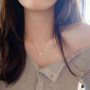 Close-up of S925 silver moissanite halo necklace worn by a female model