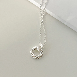 Macro shot of 925 silver Mobius twist pendant necklace with refined rope texture