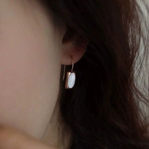 Elegant S925 sterling silver shell earrings in rose gold finish worn on female ear