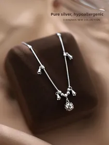 Macro shot of S925 sterling silver palace bell bracelet with hollow floral pendant