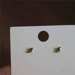 Close-up of marquise-cut olive green crystals on gold-plated S925 silver stud earrings