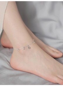 Detailed close-up of S925 sterling silver bell bracelet with hollow floral engraving