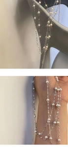 Detail view of long S925 silver chain with white pearls wrapped around the hand