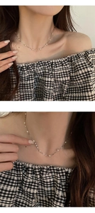 Detail of s925 silver chain necklace featuring delicate mini pearls on a model neck