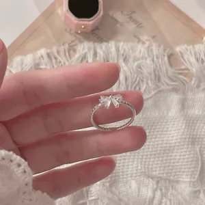 Close-up of S925 sterling silver bow ring with white marquise zircon and twisted band