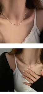 Close-up of elegant gold S925 silver necklace featuring small round white pearls for women