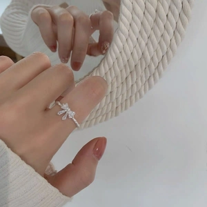 Detail of S925 sterling silver bow ring with zircon pavé setting on a model finger
