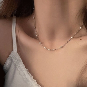 Elegant S925 sterling silver necklace with delicate pearls and shimmering chain on model