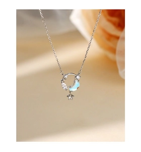Detalle del collar de plata S925 con colgante de luna azul y estrella de circón