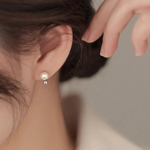 Minimalist S925 sterling silver freshwater pearl stud earrings on a female model