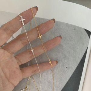 Detailed view of silver and gold S925 sterling silver minimalist cross pendant necklaces