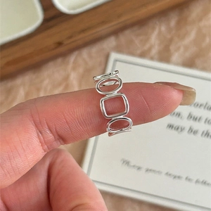 Detail of S925 sterling silver hollow geometric square and round open ring on finger