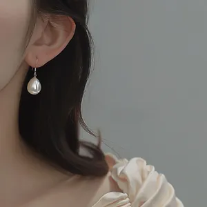 Detail of S925 silver water drop pearl earring on model showcasing elegant luster