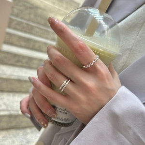 Detail of minimalist S925 sterling silver hollow geometric rings worn on a hand
