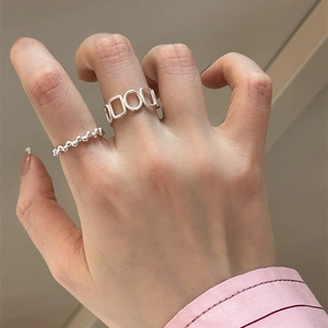 Close-up of minimalist S925 sterling silver geometric hollow rings worn on fingers