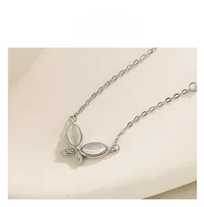 Macro view of S925 silver butterfly pendant with cat-eye stones and pavé cubic zirconia