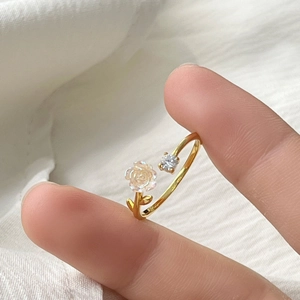 Close-up of S925 silver camellia ring with frosted flower and sparkling zircon detail