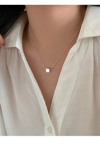 Detailed view of S925 silver sugar cube pendant on a delicate beaded chain necklace