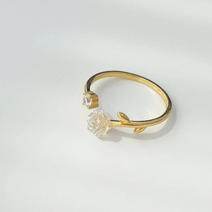 Detailed view of a gold camellia open ring featuring delicate petals and crystal accents