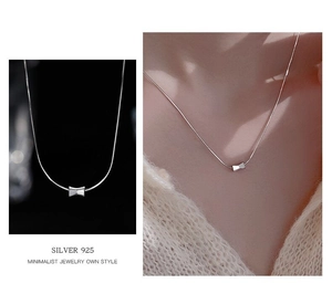 Detailed view of S925 sterling silver bow necklace with elegant minimalist pendant