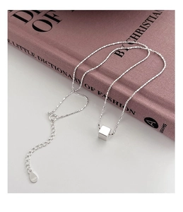 Close-up of S925 sterling silver cube necklace with adjustable chain and S925 hallmark tag