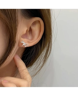 Nahaufnahme minimalistischer S925 Sterlingsilber Schleifenohrringe am Ohr eines Models