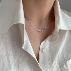 Minimalist S925 sterling silver cylinder pendant necklace on a female model with white shirt