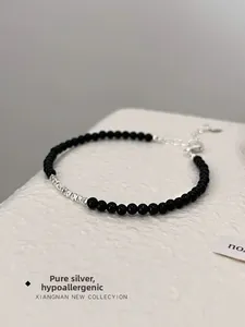 Detailed macro view of S925 sterling silver beads and black onyx stones on the bracelet