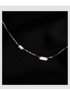 Gros plan sur la chaîne en argent S925 avec un pendentif carré poli gravé Lucky