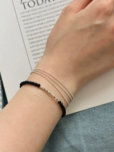Detail of S925 silver beaded bracelet set with black onyx and textured metal tube