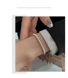 Minimalist S925 sterling silver beaded bracelet on wrist with black suit sleeve