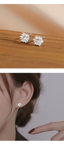 Macro shot and model wearing silver sunflower earrings with sparkling cubic zirconia