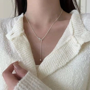 Elegant S925 sterling silver beaded tassel necklace worn on woman with white knit cardigan