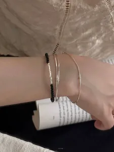 Close-up of S925 sterling silver bead bracelet with black onyx stones on female wrist