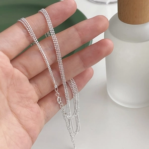 Detail of layered S925 sterling silver beaded necklace with lobster clasp and extender