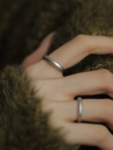 Close-up of minimalist matte S925 sterling silver ring with textured frosted finish
