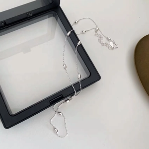 Detail of S925 sterling silver necklace featuring smooth oval beads and lobster clasp