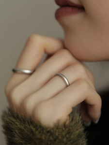 Detail of matte S925 sterling silver rings worn on fingers with minimalist design