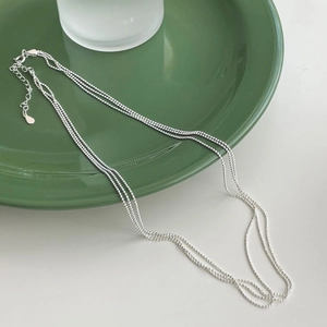 Detail of S925 sterling silver triple layer beaded necklace with adjustable drop pendant
